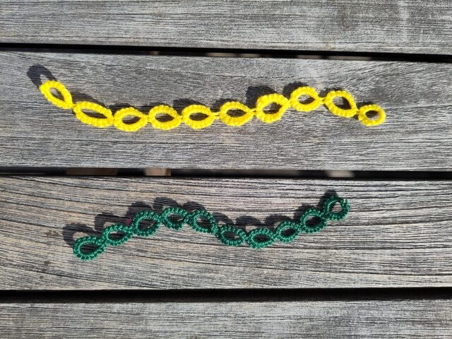 Ein gelber und ein grüner Reihenzähler. Sie besteht jeweils aus einer Kette von 10 Occhiringen.